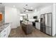 Bright kitchen features white cabinets, stainless steel appliances, granite countertops, and a kitchen island at 2513 Regal River Rd, Valrico, FL 33596