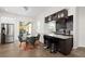 Modern kitchen with granite countertops, stainless steel appliances, dark wood cabinets, and bar seating at 2513 Regal River Rd, Valrico, FL 33596