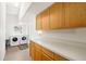Convenient laundry room featuring modern appliances, ample storage space, and a bright, functional layout at 2513 Regal River Rd, Valrico, FL 33596