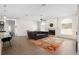 Spacious living room with a fireplace, a ceiling fan, and wood-look tile floors at 2513 Regal River Rd, Valrico, FL 33596