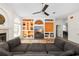 Living room with bright decor, ceiling fan, built-in shelves, and lots of natural light at 2513 Regal River Rd, Valrico, FL 33596