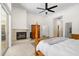Bright main bedroom with fireplace, ceiling fan, and a sliding glass door that provides plenty of natural light at 2513 Regal River Rd, Valrico, FL 33596