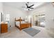 Spacious main bedroom with a ceiling fan, and sliding glass doors with a view of the pool at 2513 Regal River Rd, Valrico, FL 33596