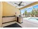 Outdoor kitchen area with built-in appliances, counter space, and views of the inviting screened-in pool area at 2513 Regal River Rd, Valrico, FL 33596