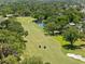 Stunning aerial view of golf course surrounded by lush trees, sand traps, and water hazards at 2525 Madrid S Way, St Petersburg, FL 33712