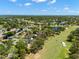 Expansive aerial view of a golf course community with multiple holes, lakes, and lush landscaping at 2525 Madrid S Way, St Petersburg, FL 33712