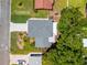 An aerial view of a house with a new roof, a paved driveway, and manicured landscaping at 2525 Madrid S Way, St Petersburg, FL 33712