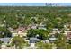 An aerial view of a neighborhood near the city, featuring mature trees and neatly arranged residential houses at 2525 Madrid S Way, St Petersburg, FL 33712