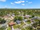 An aerial shot showing the property's neighborhood featuring mature trees and a great view of the city skyline at 2525 Madrid S Way, St Petersburg, FL 33712