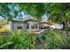 Discover a backyard oasis with privacy from lush greenery, including a screened patio at 2525 Madrid S Way, St Petersburg, FL 33712