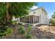 Enjoy the outdoors on a screened patio, surrounded by lush greenery and a stone pathway at 2525 Madrid S Way, St Petersburg, FL 33712
