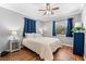 This bedroom boasts hardwood floors, neutral grey walls, and a ceiling fan for added comfort at 2525 Madrid S Way, St Petersburg, FL 33712