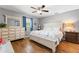Bright bedroom featuring hardwood floors, a queen bed, and stylish furnishings at 2525 Madrid S Way, St Petersburg, FL 33712
