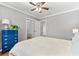 This bedroom has hardwood floors, a ceiling fan, neutral grey walls, and direct access to a walk-in closet at 2525 Madrid S Way, St Petersburg, FL 33712