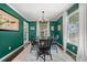 Dining room featuring a wooden table, black chairs, a chandelier, and bright-green colored walls at 2525 Madrid S Way, St Petersburg, FL 33712