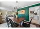 Inviting dining room with wood table, black chairs, decorative chandelier and view into the living room at 2525 Madrid S Way, St Petersburg, FL 33712