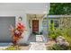 Charming front entrance with a covered porch, stone walkway, and fresh landscaping at 2525 Madrid S Way, St Petersburg, FL 33712