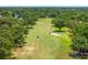 Scenic aerial view of golf course featuring lush greens, sand traps, and players enjoying a round of golf at 2525 Madrid S Way, St Petersburg, FL 33712