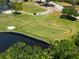 Aerial view of golf course highlighting lush green, water features, sand traps and players enjoying the course at 2525 Madrid S Way, St Petersburg, FL 33712