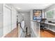 Upstairs hallway with white closet doors, open stairwell, and view of desk area at 2525 Madrid S Way, St Petersburg, FL 33712