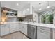 Bright eat-in kitchen with white cabinets, stainless steel appliances, and a colorful window valance at 2525 Madrid S Way, St Petersburg, FL 33712