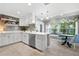 Bright eat-in kitchen with white cabinets, stainless steel appliances, breakfast nook with backyard view at 2525 Madrid S Way, St Petersburg, FL 33712