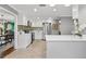 Modern kitchen with stainless steel appliances, white cabinets and countertops, and tile backsplash at 2525 Madrid S Way, St Petersburg, FL 33712