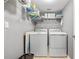 Well-organized laundry room featuring a washer, dryer and wire rack shelving at 2525 Madrid S Way, St Petersburg, FL 33712