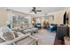 Open-concept living room with large windows, hardwood floors, and stylish decor at 2525 Madrid S Way, St Petersburg, FL 33712
