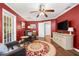 Comfortable living room featuring rich red walls, hardwood floors, and comfortable leather seating arrangement at 2525 Madrid S Way, St Petersburg, FL 33712