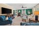 Comfortable living room with sofas, chairs, large windows, green walls, and media center at 2525 Madrid S Way, St Petersburg, FL 33712