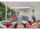 Relax in this screened patio with comfortable seating, a dining area, and views of the serene outdoor space at 2525 Madrid S Way, St Petersburg, FL 33712