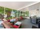 Relax in this screened patio with comfortable seating, a dining area, and views of the serene outdoor space at 2525 Madrid S Way, St Petersburg, FL 33712