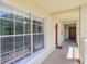 Balcony with large windows featuring metal bars and exterior walkway at 2690 Coral Landings Blvd # 122, Palm Harbor, FL 34684