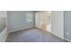 Carpeted bedroom with window view, white trim and paneled doors to other rooms at 2690 Coral Landings Blvd # 122, Palm Harbor, FL 34684