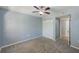 Bright bedroom features fresh grey paint, carpet, a ceiling fan and a double-door closet at 2690 Coral Landings Blvd # 122, Palm Harbor, FL 34684