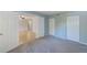 This carpeted bedroom features an open doorway to another room, and a closet at 2690 Coral Landings Blvd # 122, Palm Harbor, FL 34684
