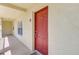 View of front door to unit featuring stucco and welcome mat at 2690 Coral Landings Blvd # 122, Palm Harbor, FL 34684