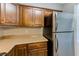 Well-lit kitchen featuring stainless steel refrigerator, sleek countertops, and ample cabinet space at 2690 Coral Landings Blvd # 122, Palm Harbor, FL 34684