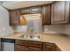 Well-lit kitchen boasts stainless steel sink, sleek countertops and stainless steel dishwasher at 2690 Coral Landings Blvd # 122, Palm Harbor, FL 34684