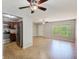 Open-concept living room with a view of the kitchen, tile flooring, and natural light at 2690 Coral Landings Blvd # 122, Palm Harbor, FL 34684