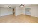 Open-concept living room featuring tile floors, ceiling fans, and access to the kitchen at 2690 Coral Landings Blvd # 122, Palm Harbor, FL 34684