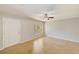 Open-concept living room featuring tile floors, a ceiling fan, and a sunlit window at 2690 Coral Landings Blvd # 122, Palm Harbor, FL 34684