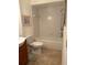 Bathroom with tile floor, tub and shower, and a wood vanity sink at 2961 Flint N Dr, Clearwater, FL 33759