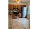 Well-lit kitchen with wooden cabinets, stainless steel appliances including stainless refrigerator at 2961 Flint N Dr, Clearwater, FL 33759