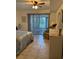 Bright bedroom with tile floors, a queen bed, and sliding glass doors to outdoor patio at 2961 Flint N Dr, Clearwater, FL 33759