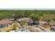 Gorgeous aerial view of backyard pools with screened enclosures surrounded by lush trees at 3041 Avalon Terrace Dr, Valrico, FL 33596