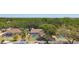 Inviting aerial view of three backyard pools, each enclosed by screened-in or fenced-in areas, surrounded by lush greenery at 3041 Avalon Terrace Dr, Valrico, FL 33596