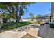 Backyard patio and screened-in pool area offer a relaxing outdoor space, complemented by mature trees and a white fence at 3041 Avalon Terrace Dr, Valrico, FL 33596