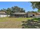 A backyard with a screen-enclosed pool, lush greenery, and a well-maintained lawn offers a private outdoor retreat at 3041 Avalon Terrace Dr, Valrico, FL 33596